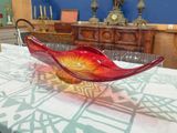 brightly colored glass bowl sitting on top of a table in a room