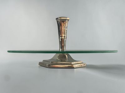 a glass table with a metal candle holder on it