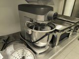 a mixer on the counter with a strainer on top of it