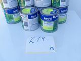 several cans of astrall on a table with a price tag