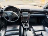a picture of a car dashboard with leather seats and a steering wheel