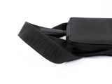 a black purse with a black strap on a white background