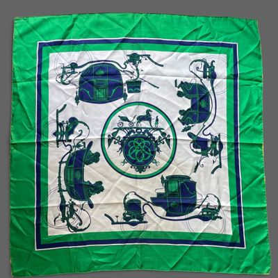 a close up of a green and white scarf with a picture of a car