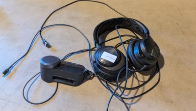 a pair of headphones and a charger on the floor