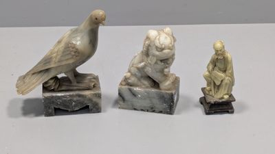 three statues of birds sitting on top of a table next to each other