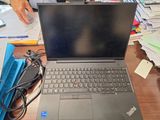 a laptop that is sitting on a desk with papers