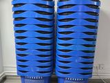 deux bacs en plastique bleus posés sur un plancher en bois