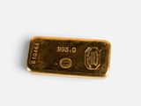 a close up of a gold bar on a white surface