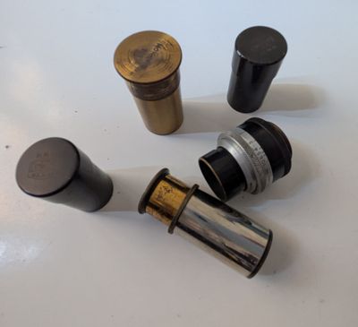 several different types of brass and black knobs on a white surface