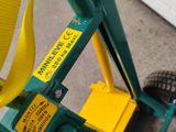 a green cart with a yellow handle and a black handle
