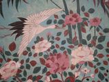 a painting of a bird and flowers on a plate