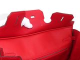 red leather handbag on white background with clippings on the handle