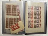 an open book with stamps on it sitting on top of a table