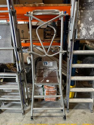 a ladder that is sitting next to a pile of boxes