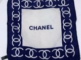 blue and white chanel scarf on a white plate on a white table