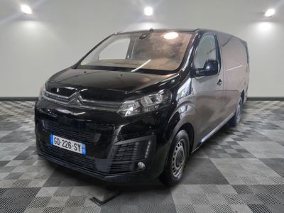 the black van is parked in a large room with a checkered floor