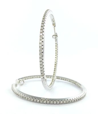 a pair of diamond hoop earrings on a white background