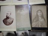 many old photos of women and men sitting on a table