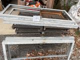 a pile of old windows that are sitting on the ground