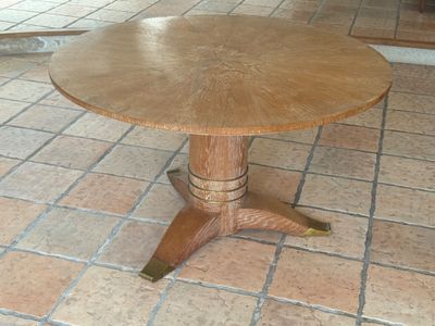 a wooden table on a tile floor in a room