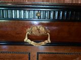 a wooden cabinet with a brass handle on it