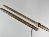 pair of antique wooden and brass - plated swords with brass - plated handles