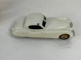 a white toy car that is sitting on a table