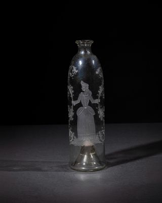a glass bottle with a picture of a woman inside of it