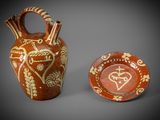 two vases with designs on them sitting next to each other