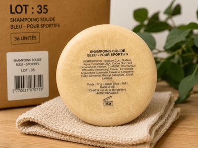 a soap bar sitting on top of a towel next to a box of soap