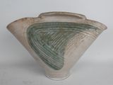 a white vase with a green design on it