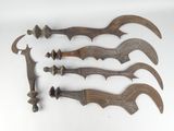 four wooden knives are lined up on a white surface