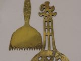 a gold spoon and a gold fork on a table