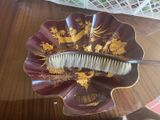 a hair brush sitting on top of a plate on a table