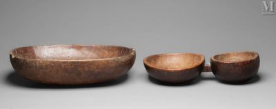 two wooden bowls and a bowl on a gray surface