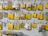 a wall with many boxes and packages hanging on it
