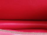 the inside of a pink purse with a zipper on the inside