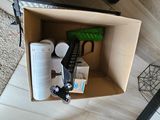 a cardboard box with a remote control and other items in it