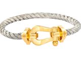 une photo d'un bracelet en argent et en or muni d'un fermoir