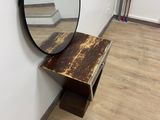 a mirror that is on the wall next to a table