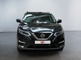 the front of a black nissan qx parked in a showroom