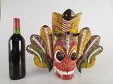 a bottle of wine next to a mask and a bottle of wine