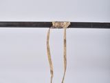 a piece of rope hanging from the side of a pole