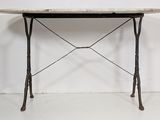an image of a table with a marble top and iron legs