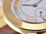 a close up of a gold watch with a brown strap