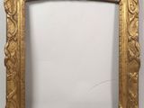 an old gold frame with a decorative design on it