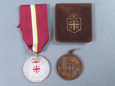 medals and a book sitting on a table next to each other