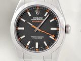a close up of a watch with a black dial