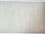 an old piece of paper sitting on top of a white table