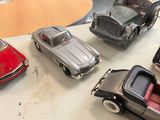several toy cars are lined up on a table next to each other